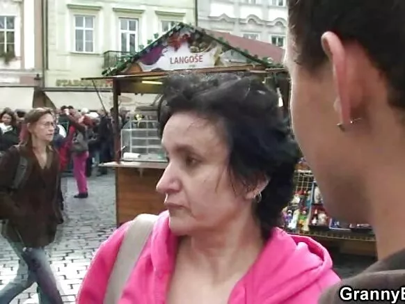 Mamamama atijọ pẹlu awọn ori omu nla, oniriajo mamamama ti ogbo ti fo lori akukọ rẹ.